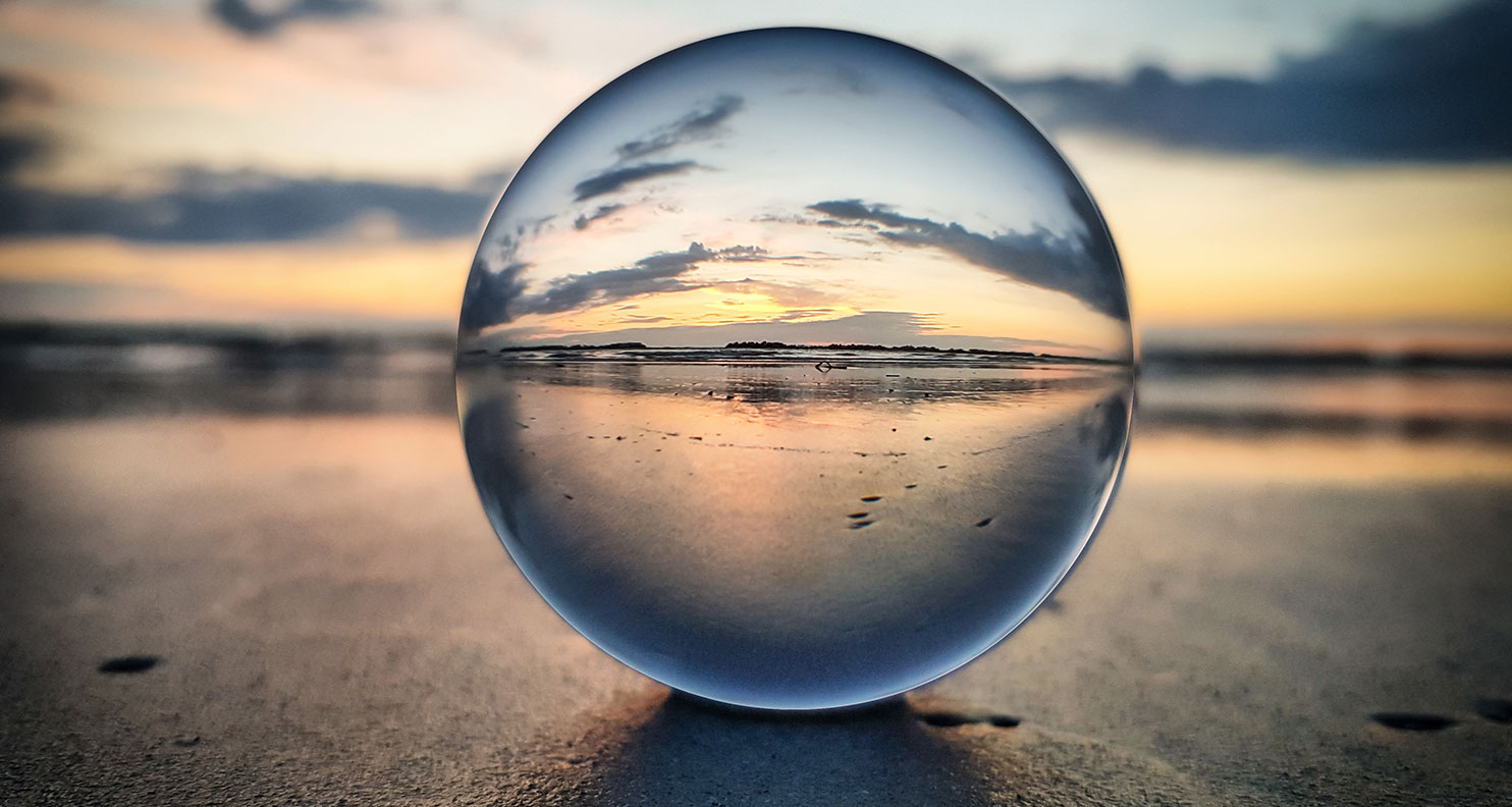Beach viewed through glass orb