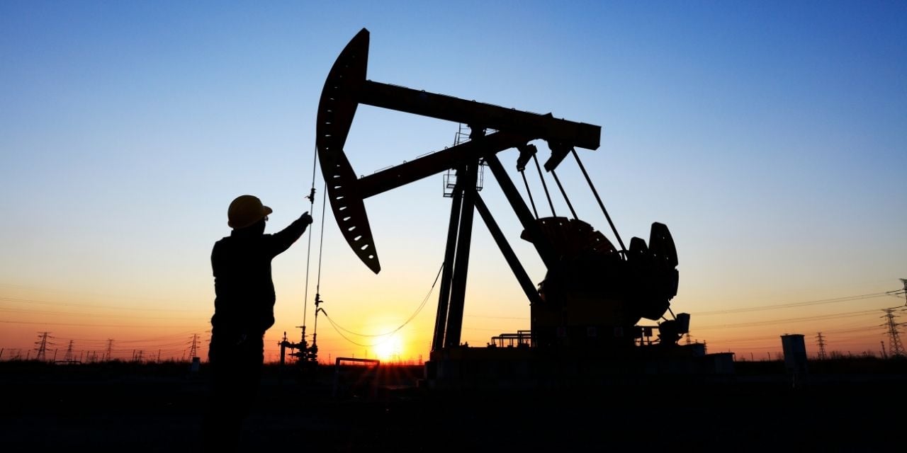 Working in oil field at sunrise