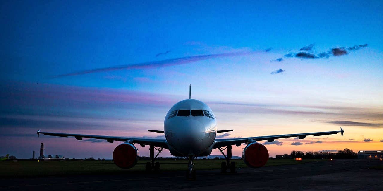 Airplane on the runway at sunset