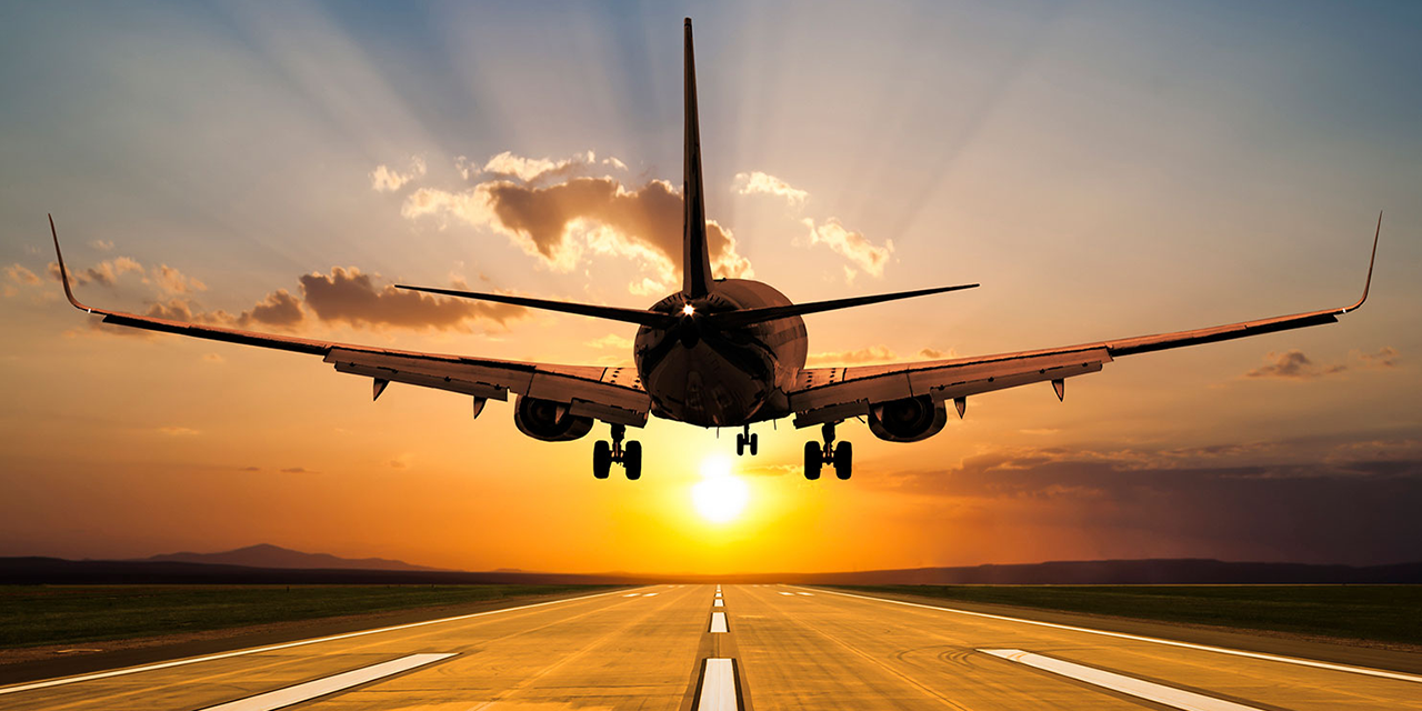 Airplane landing at sunset