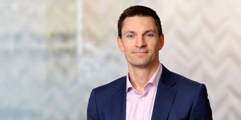 Horizonal image of Michael Holgate with chevron background