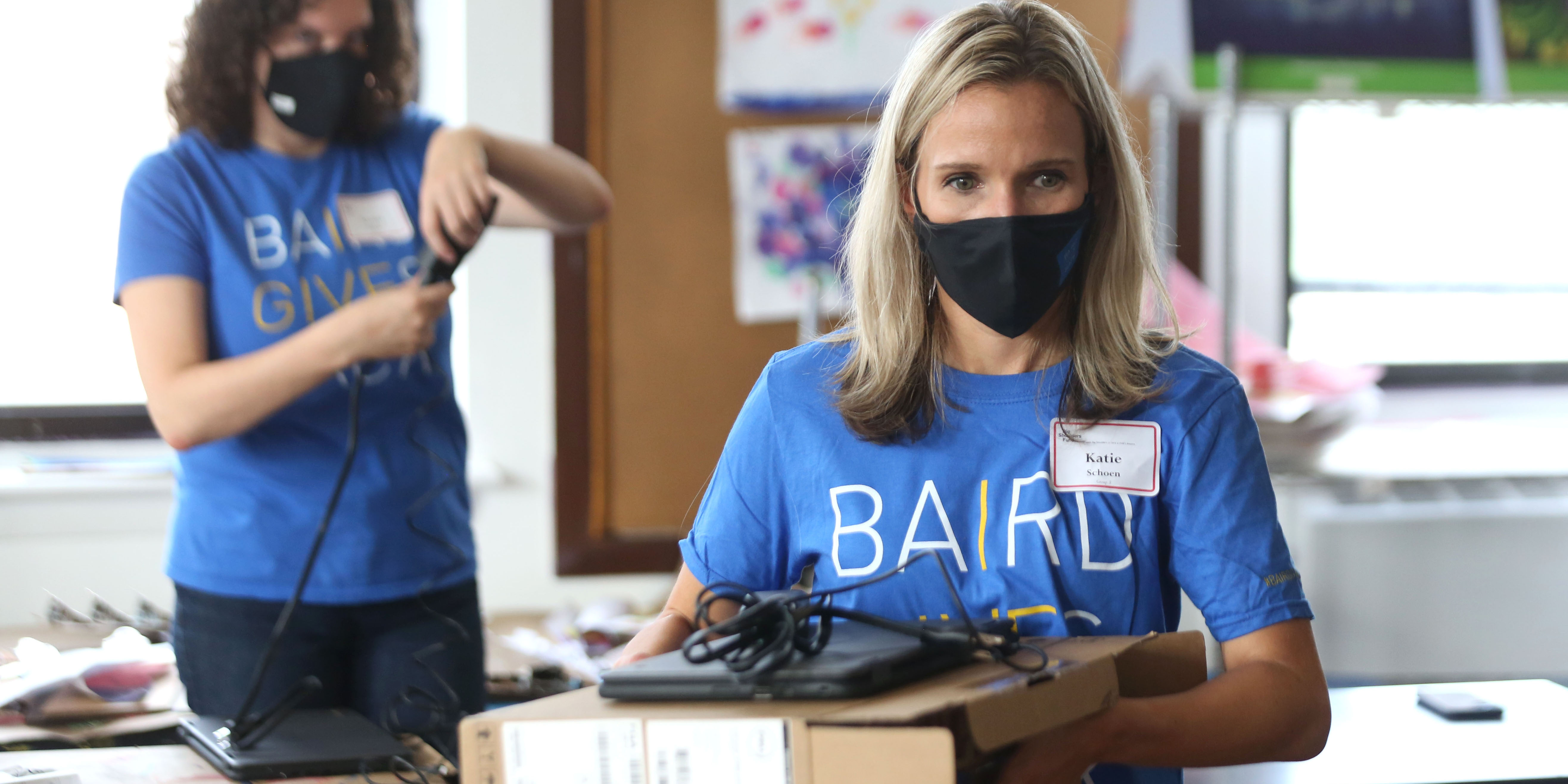 Two Baird Capital associates volunteering in a classroom. 