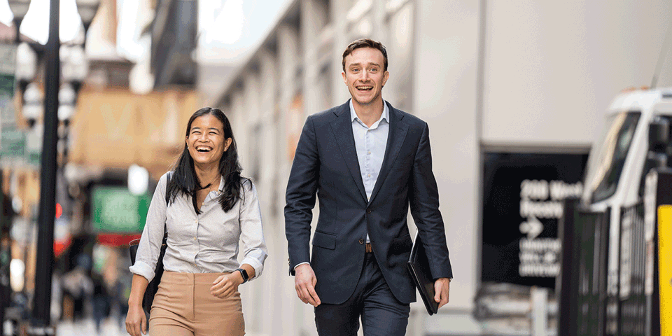 Two business associates walking down a city street