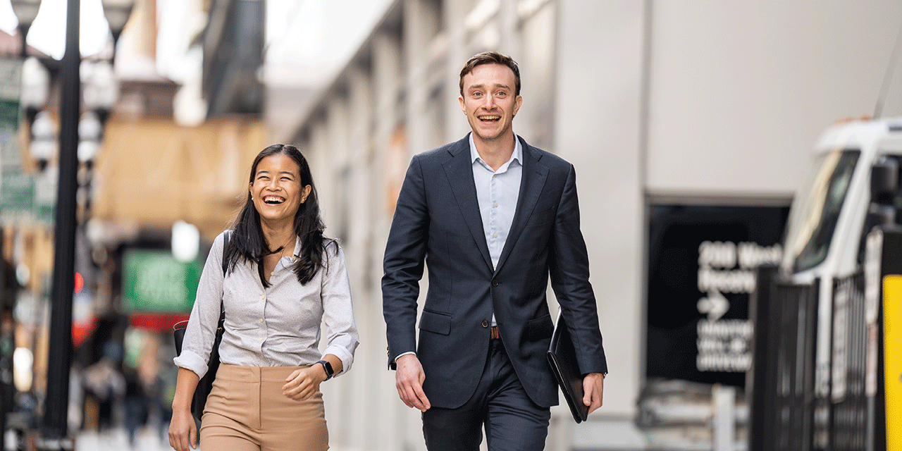 Two business associates walking down a city street