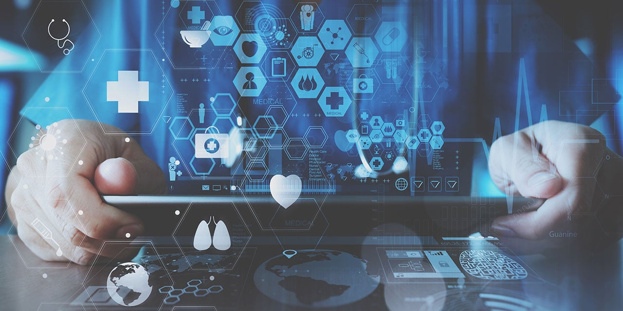Medical professional holding ipad with icons floating over it.