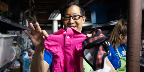 Gordon Pan, Baird Capital, sorting pet accessories during a volunteer event.