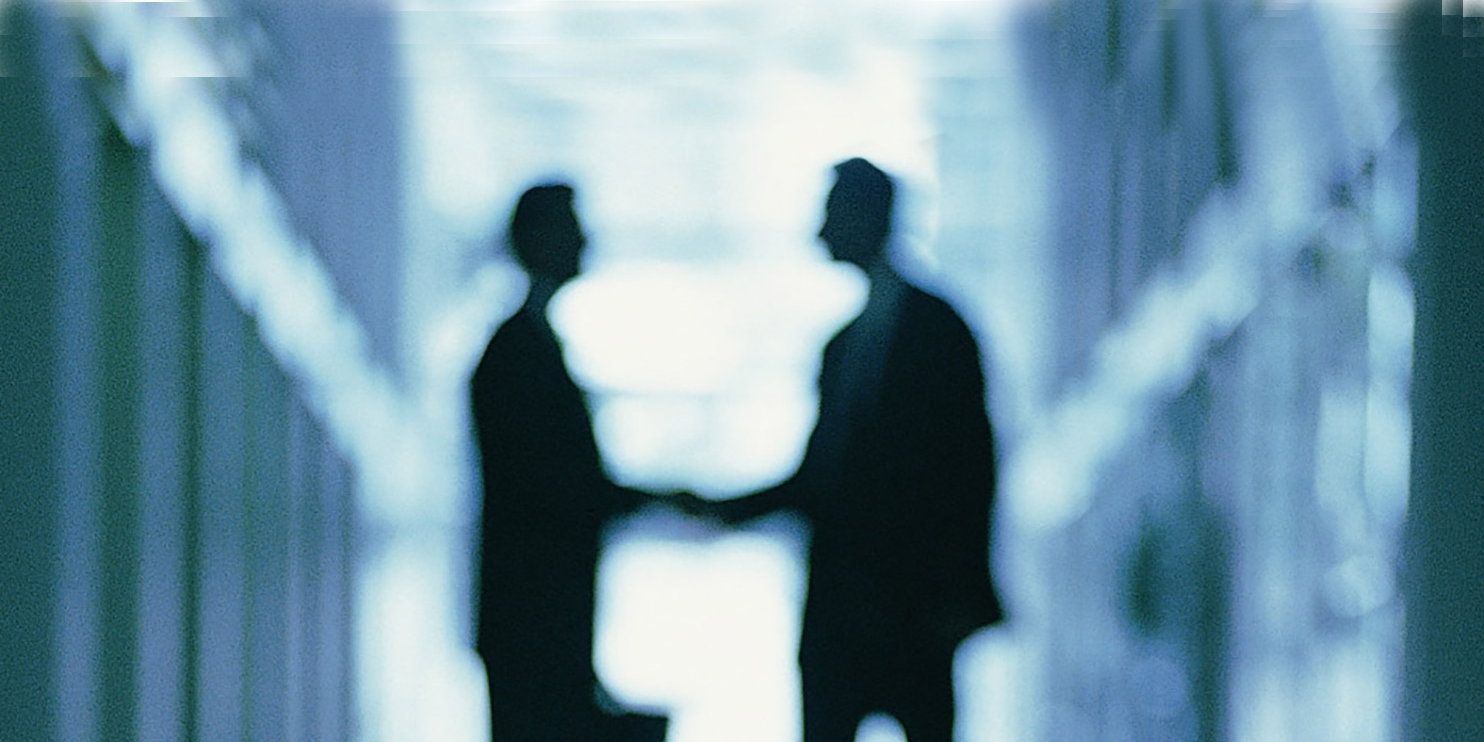  Blurred image of professionals shaing hands
