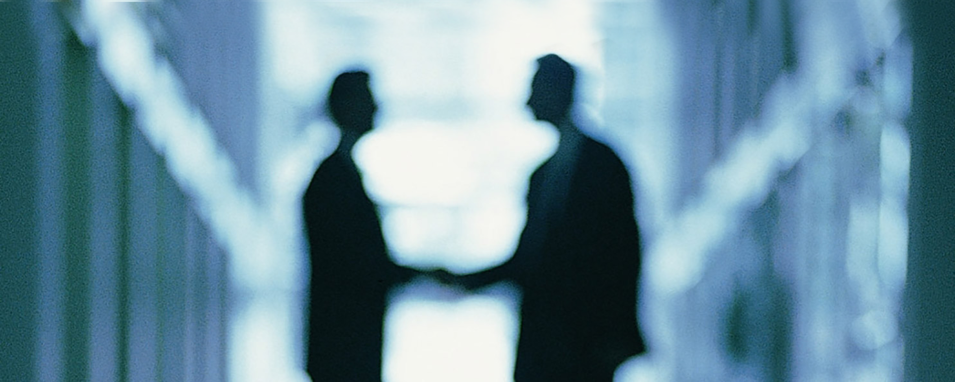  Blurred image of professionals shaing hands