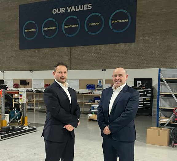 Two professionals standing in a warehouse