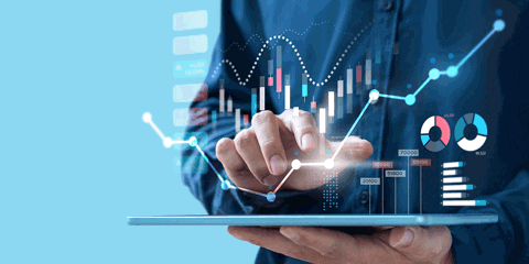 Hands holding tablet with financial graphics superimposed onto image.