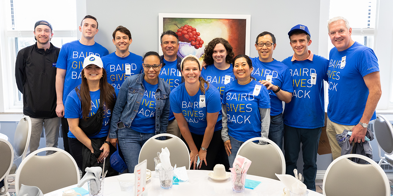 Group of Baird Capital associates wearing Baird Gives back t-shirts at a volunteer event