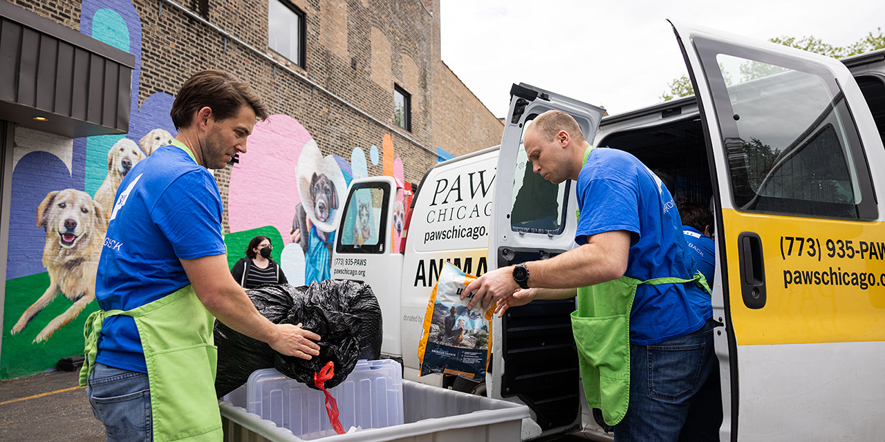 Two Baird Capital associates unloading a van during a volunteer event